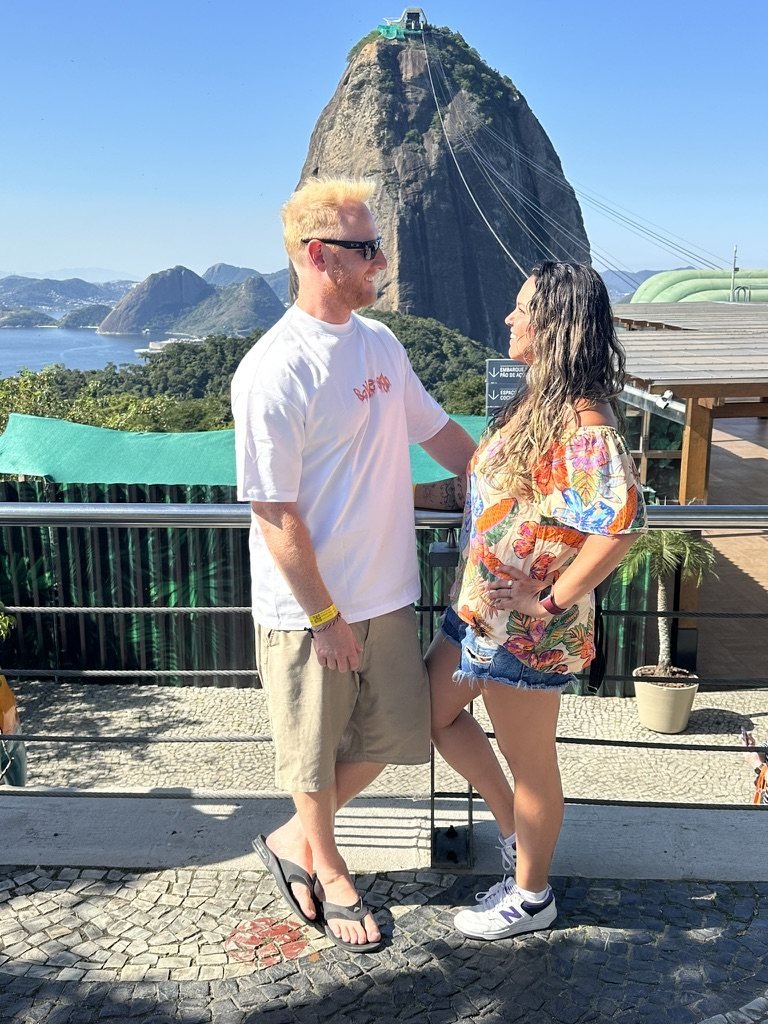 Joyce and Tristan facing each other at the Sugarloaf Mountain lookout in Rio de Janeiro